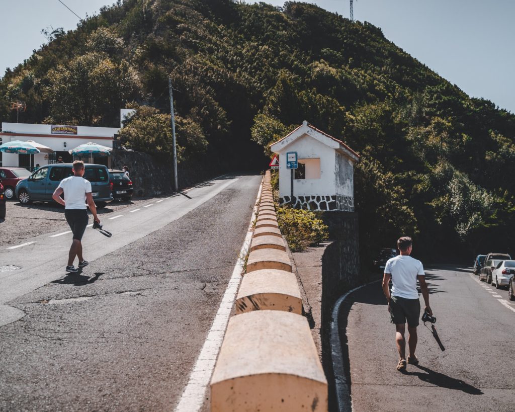 Man holding camera walking on two different paths, a new career path