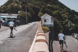 Man holding camera walking on two different paths, a new career path