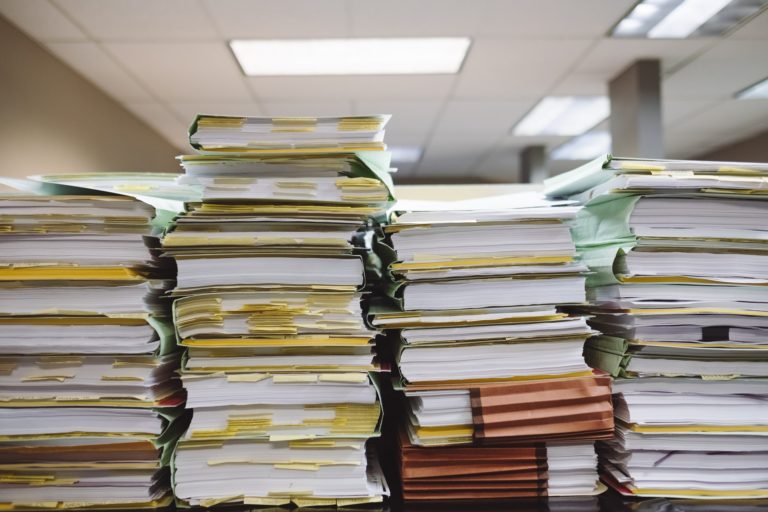 Disorganized stack of files and books
