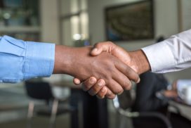 Two hands shake in agreement, how to negotiate a job offer