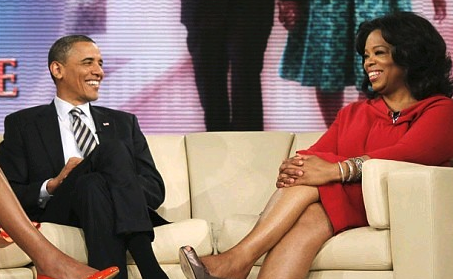 President Barack Obama and Oprah Winfrey sitting on a couch together, smiling