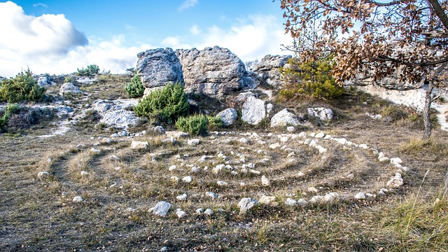 labyrinth against a rocky outcrop and blue sky