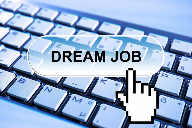 computer keyboard with an icon pointing to a floating button that says "dream job"