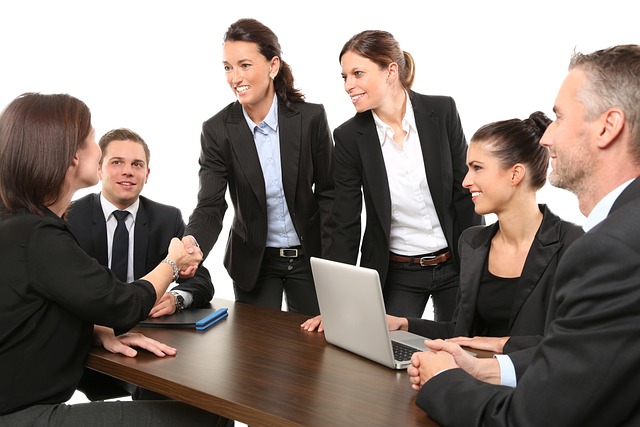 a group of people in business attire shaking hands after an interview
