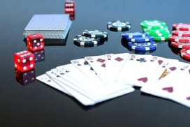 a spread of playing cards, dice, and poker chips