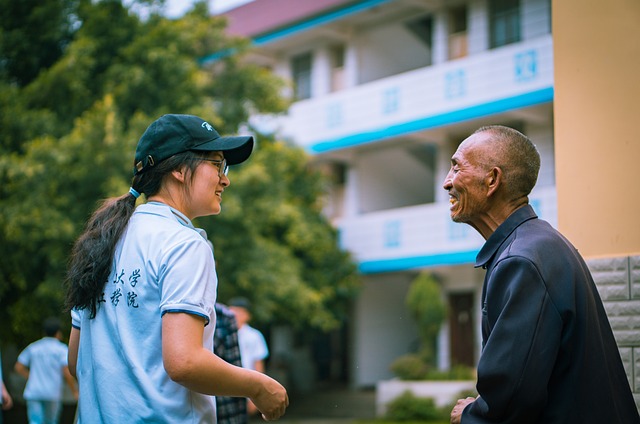 a younger volunteer working with an elder in her community