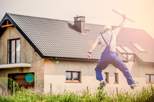 Should you be self-employed? A building contractor jumping for joy on a great project, a house in the background