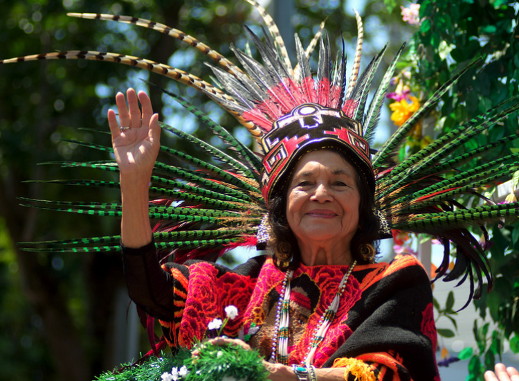 Acivist Dolores Huerta in colorful headdress with the United Farm Workers symbol on it