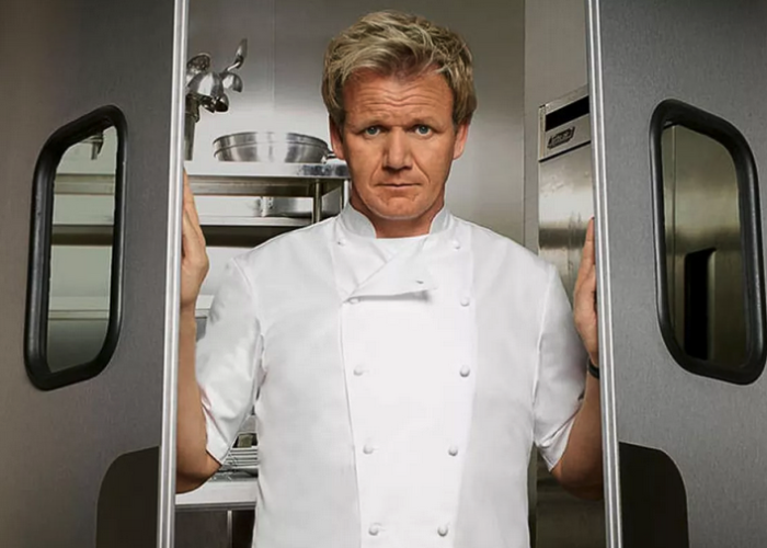 Chef Gordon Ramsay posing in front of swinging kitchen doors