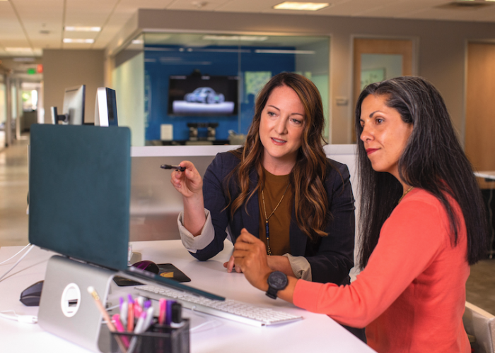 two women collaborating at a computer